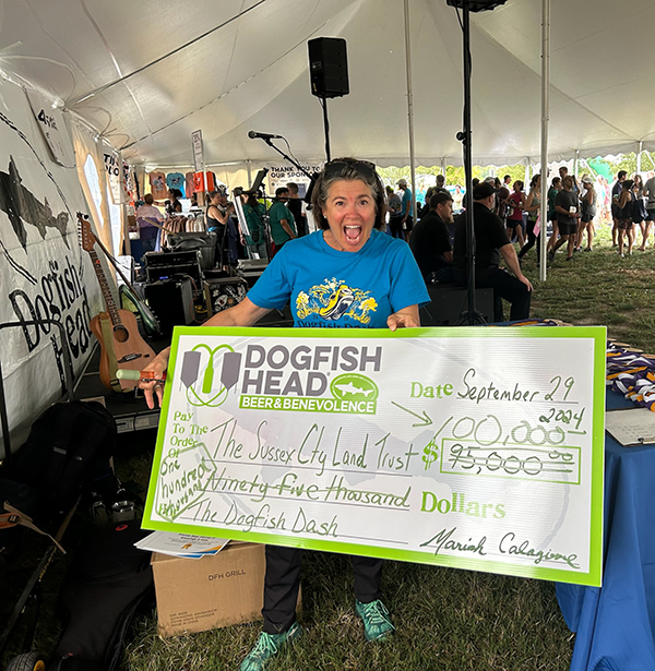 Mariah Calagione with a big check for the Sussex County Land Trust after the 2024 Dogfish Dash