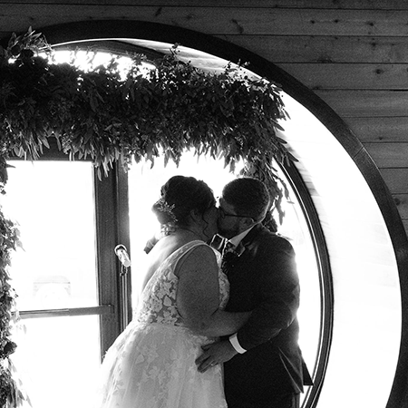 A couple kissing during a wedding at Chesapeake & Maine