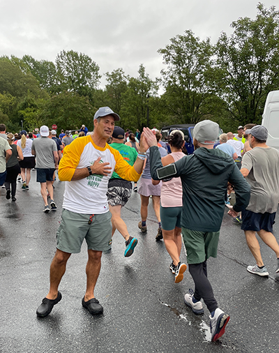 Sam Calagione hi-fiving at the finish line of the Dogfish Dash