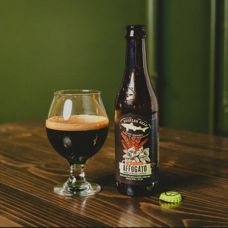 A bottle of Affogato World Wide Stout on a bed of coffee beans