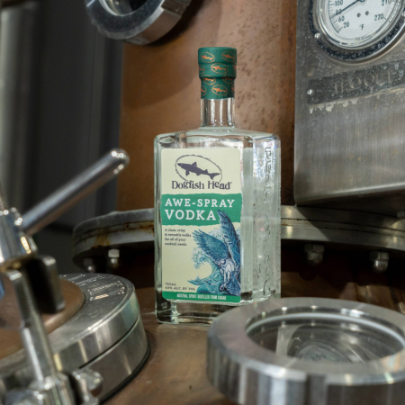 Dogfish Head Distilling Co Awe-SPray Vodka with distillery in the background 