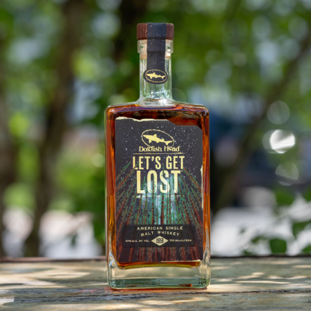 Dogfish Head Distilling Co Let's Get Lost Whiskey with trees in the background