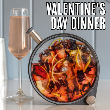 Photo of a champagne glass next to a porthole cocktail and text reading "Valentine's Day Dinner"