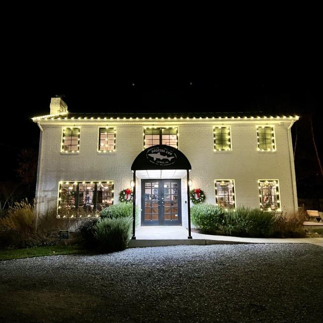 Dogfish Inn with holiday lights all over the exterior of the building