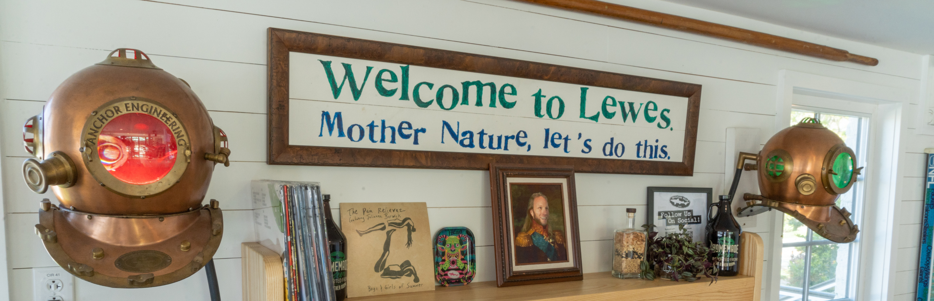 sign on the wall of the Dogfish INN that reads "Welcome to Lewes. Mother Nature, Let's Do This"